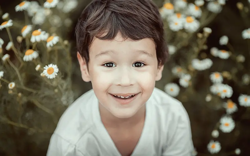 A Free Retro Photoshop Action Preview On An Image Of A Smiling Boy
