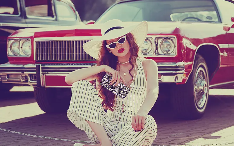 A Free Retro Photoshop Action Preview On An Image Of A Girl In Front Of A Car